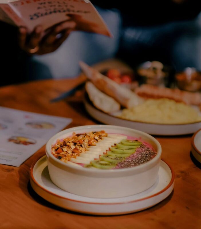 Beanlore Bengaluru Coffee Cafe: A Quiet Sanctuary for Handcrafted Brews & Calm Vibes Cozy interior of Beanlore cafe with patrons working or reading