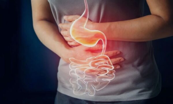 Stressed person holding stomach, symbolizing gut discomfort