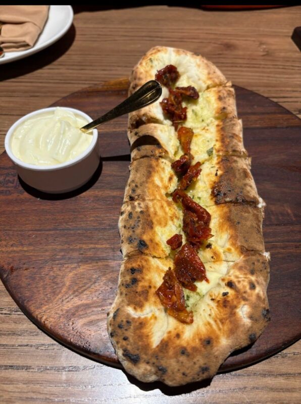 The Pizza Bakery Artisanal Pizza: Celebrating Simplicity & Quality in Every Slice Chef stretching slow-fermented dough at The Pizza Bakery