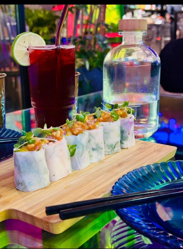 Vibrant food counter serving ramen and bao buns at Neon Market