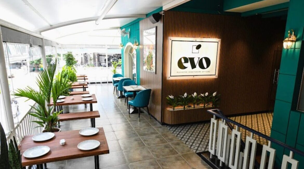 Evo is a Vibe: A Refined Dining Experience in Bangalore Chef preparing a noodle bowl at the open kitchen in Evo Restaurant