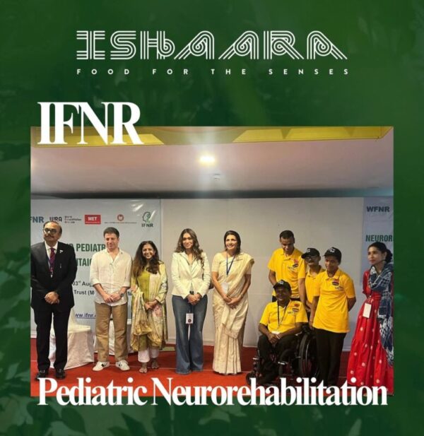 A team member at Ishaara using sign language to welcome guests