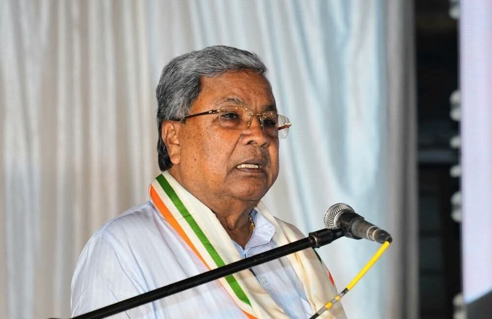 Deputy Chief Minister DK Shivakumar speaking at an event, hinting at internal party agreements.