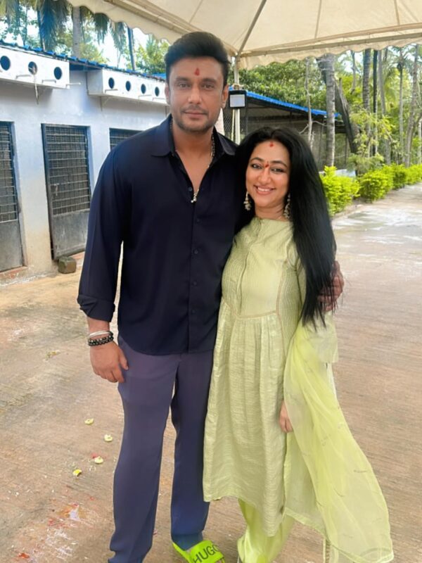 Vijayalakshmi Darshan speaking to fans during The Devil promotion, responding to remarks in the feud.

