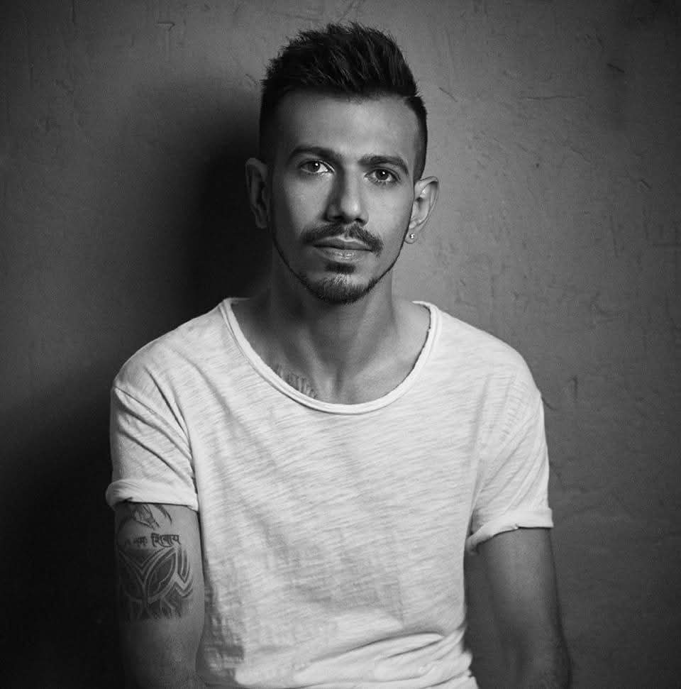 Yuzvendra Chahal at an airport or event, showcasing his overall luxury fashion style.