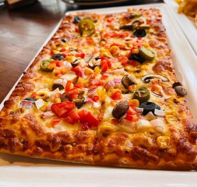 Close-up of a gourmet salad or pasta dish from the Green Theory Cafe menu.