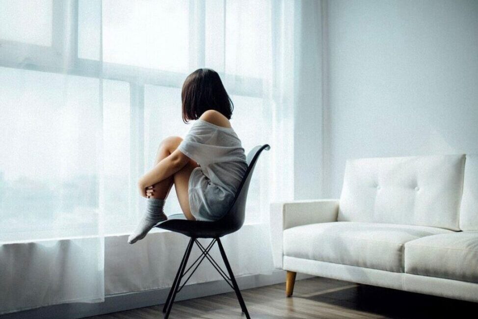 A person sitting peacefully in a quiet room, practicing 20 minutes of silence for health.