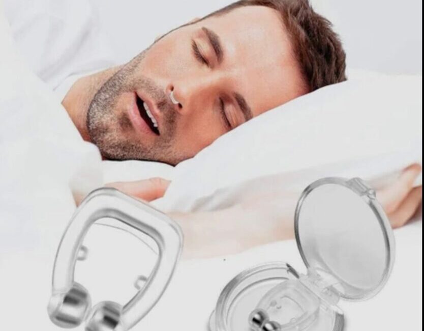 Anti-Snoring Clip: A Simple Aid for Better Sleep A soft silicone anti-snoring nose clip placed on a person's nostrils.