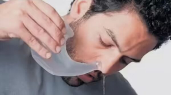 Jala Neti: A Simple Rinse for Clear Breathing A person correctly using a neti pot for saline nasal rinse (jala neti).