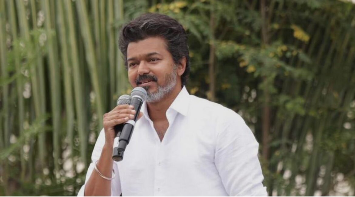 Vijay escorted by security after stumbling at Chennai International Airport.