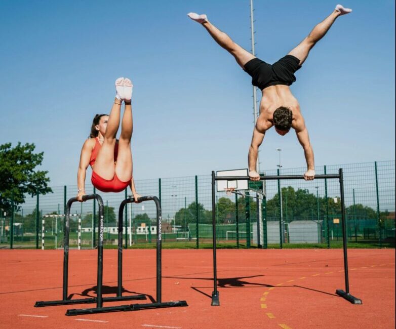 A person performing push-ups in a park during a calisthenics workout.