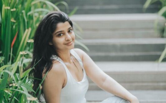 Aishani Shetty announcing her directorial debut, Kaajana, in a promotional photo.